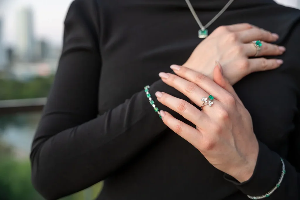 Emerald rings, emerald bracelet and pendant worn together, Eterna Jewels Austin