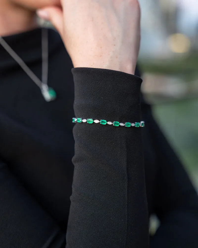 Emerald tennis bracelet and emerald pendant worn with black, Eterna Jewels Austin