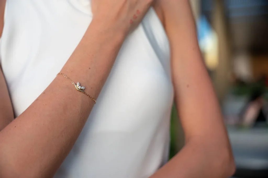 Delicate gold swan bracelet with diamonds on the wrist, Eterna Jewels Austin
